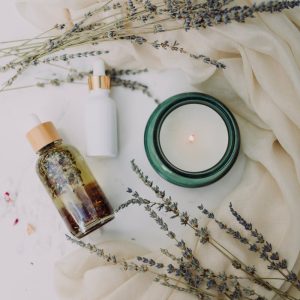 A calming flat lay of spa essentials featuring lavender and candles for relaxation.